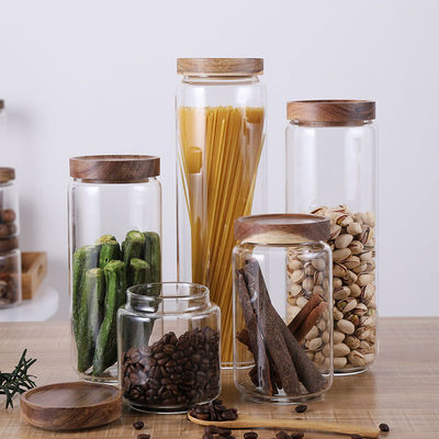Op maat gemaakte capaciteit voorraad verzegeld helder rond borosilicaat glas verpakkingscontainers pot met houten deksel