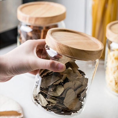 Op maat gemaakte capaciteit voorraad verzegeld helder rond borosilicaat glas verpakkingscontainers pot met houten deksel